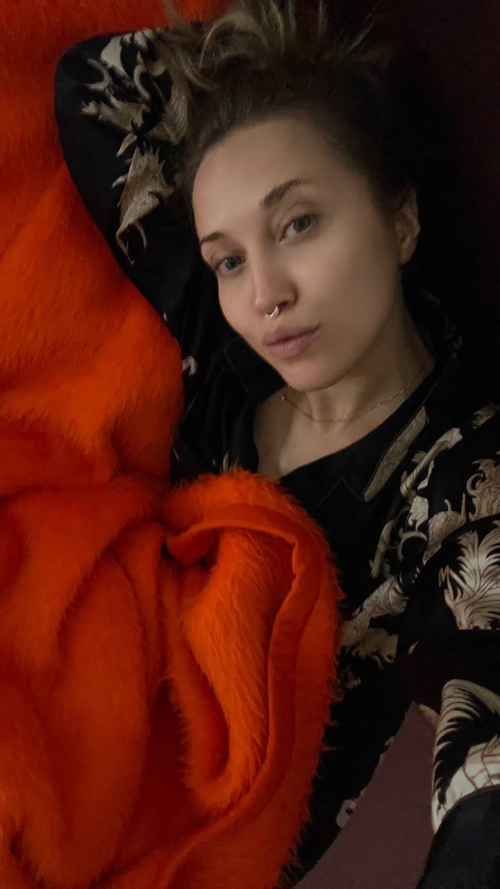 Natali Raievska photo sent via Telegram — orange blanket, bedtime selfie