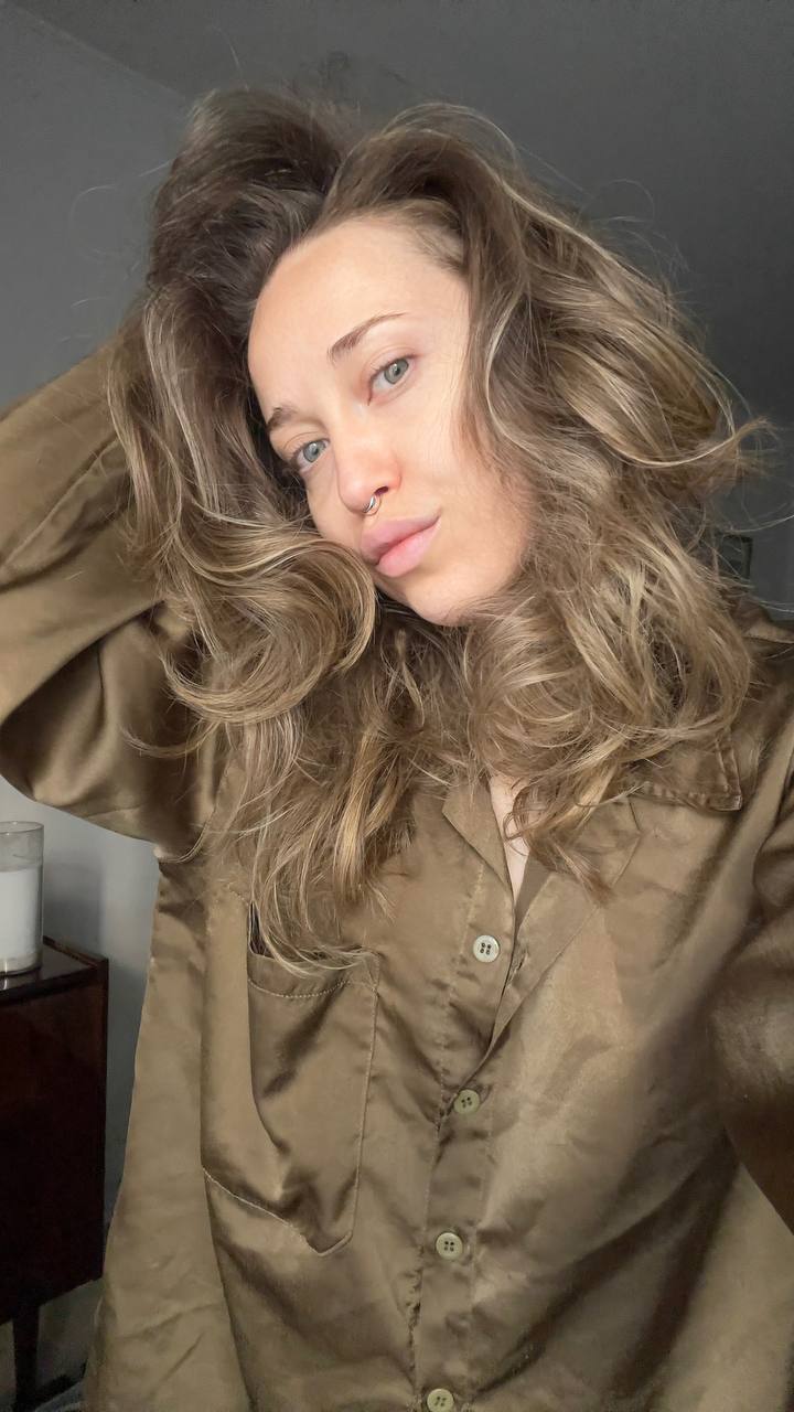 Natali Raievska in khaki satin shirt — hair down selfie