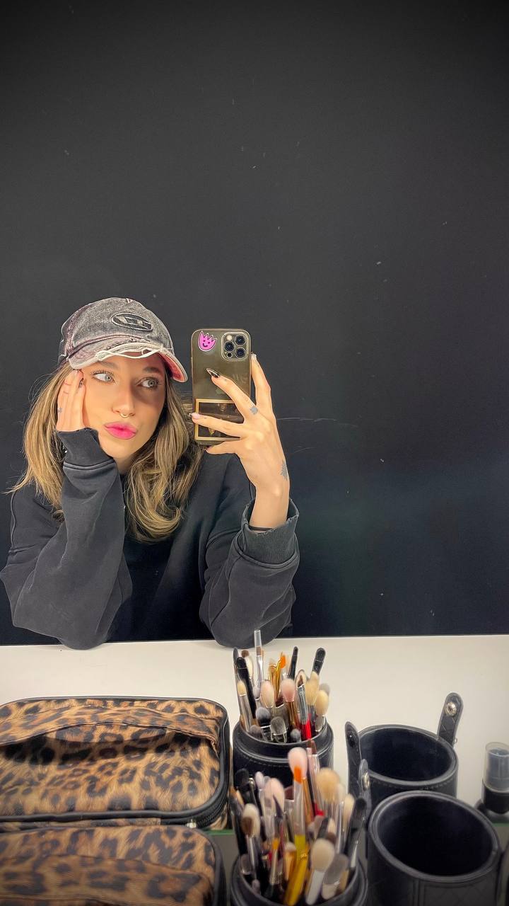 Natali Raievska at salon mirror with professional makeup brushes